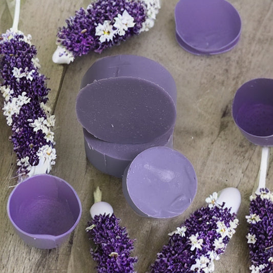 Natural shampoo bars surrounded by colorful flowers for healthier hair care.