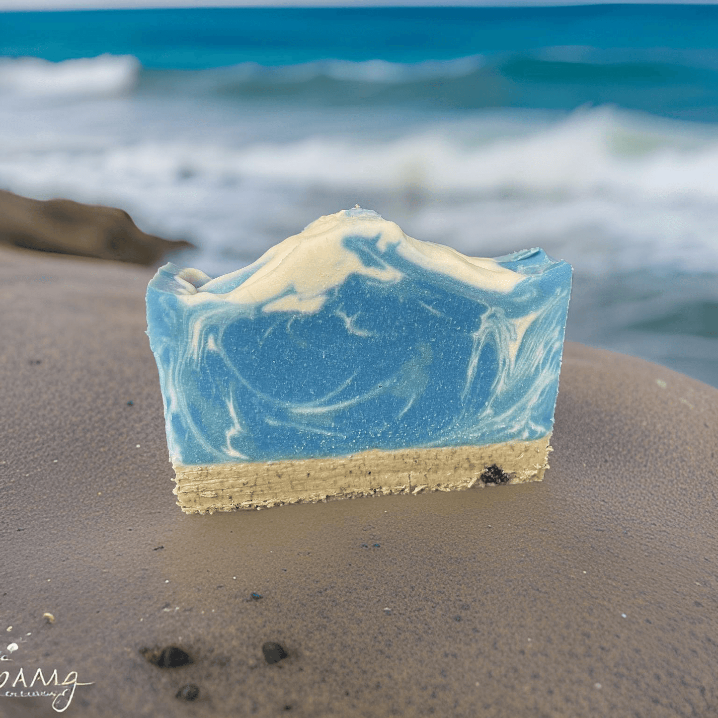Surf All-Natural Vegan Soap for Luxurious Skincare, featuring blue and beige swirls and a beach backdrop.