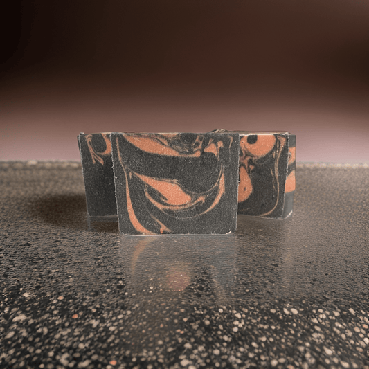 Natural vegan face soap bar with marbled pink and black design, perfect for cleansing and exfoliating.