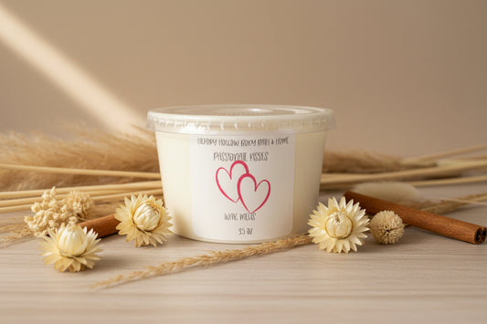 Passionate Kisses Wax Melts candle jar surrounded by decorative flowers and cinnamon sticks.