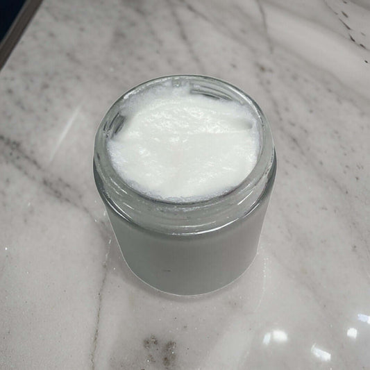 Luxury sugar scrubs in a glass jar, showcasing a creamy texture for skin exfoliation.
