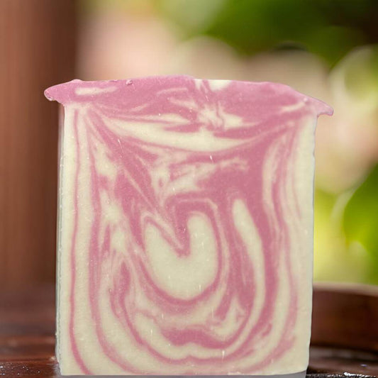 Organic honeybunny soap bar with pink and white swirls, perfect for nourishing and vegan-friendly skincare.