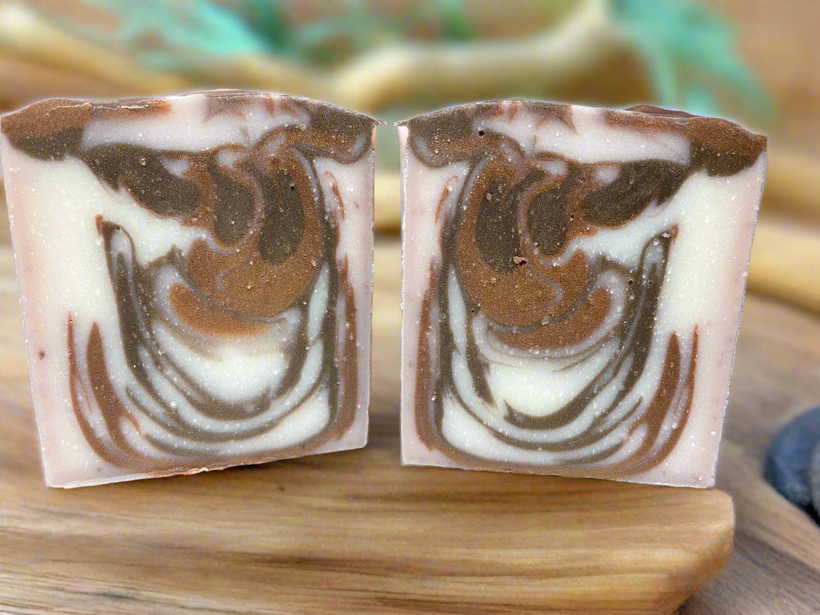 Handcrafted organic Mahogany Teakwood soap bars showcasing a rich, swirled pattern of browns and creams.