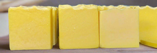 Lemongrass tallow soap bars in bright yellow, showcasing luxurious texture and natural ingredients.