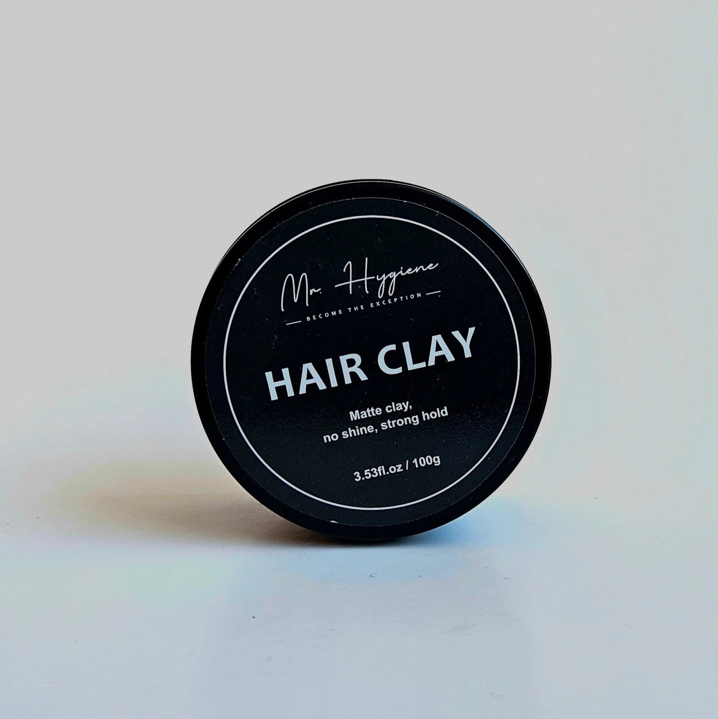 Matte Finish Hair Clay in a black container, designed for strong hold and natural look without shine.