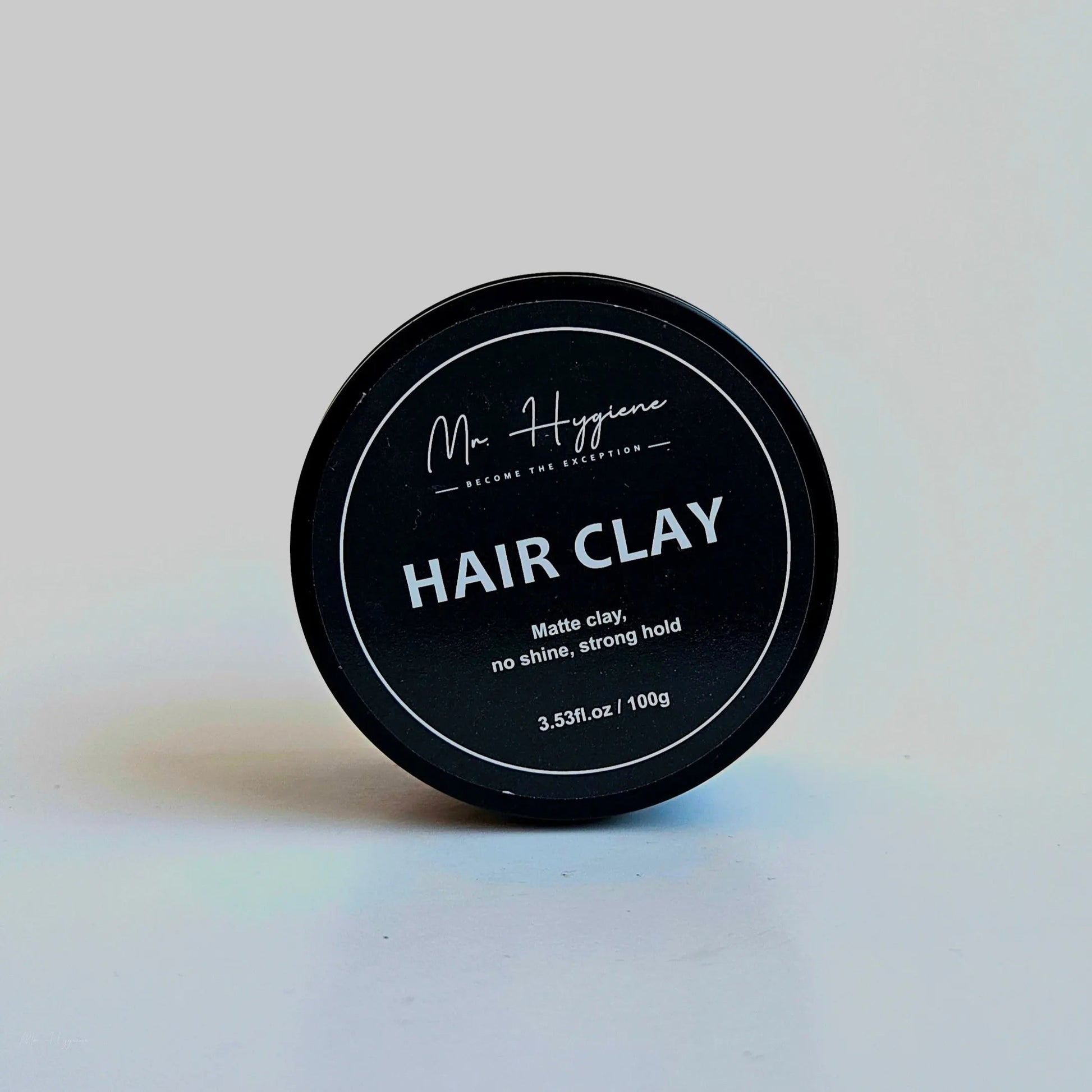 Matte Finish Hair Clay in a black container, designed for strong hold and natural look without shine.