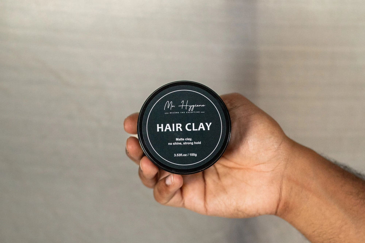Matte Finish Hair Clay in a hand, showcasing strong hold and natural look for effortless styling.