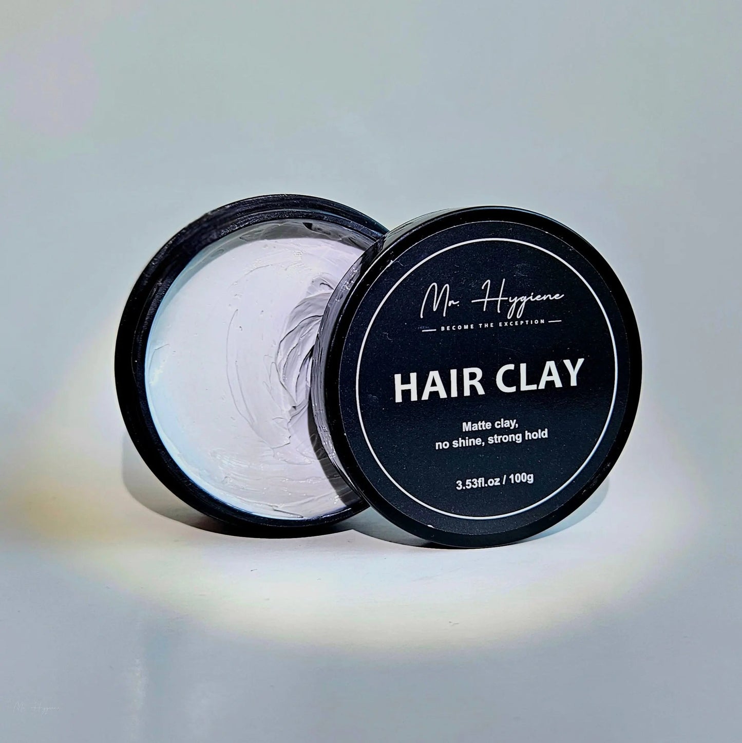 Matte Finish Hair Clay in an open container showcasing its strong hold and no shine formula for effortless styling.