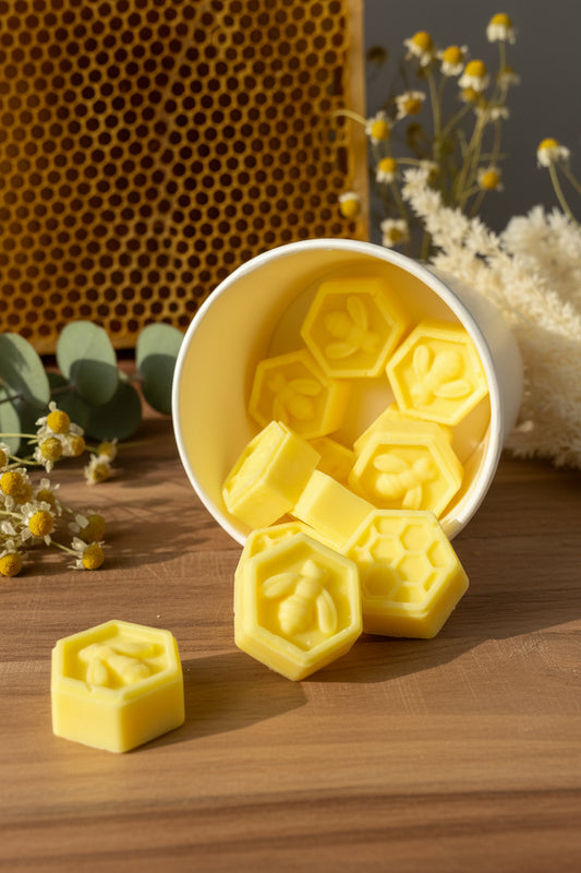Bee My Honey Wax Melts in yellow hexagonal shapes spilling from a cup, surrounded by dried flowers.