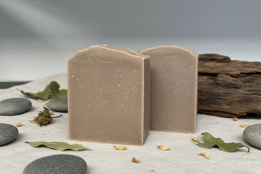 Sandalwood Tallow Soap displayed with stones and natural elements, showcasing its smooth texture and earthy color.