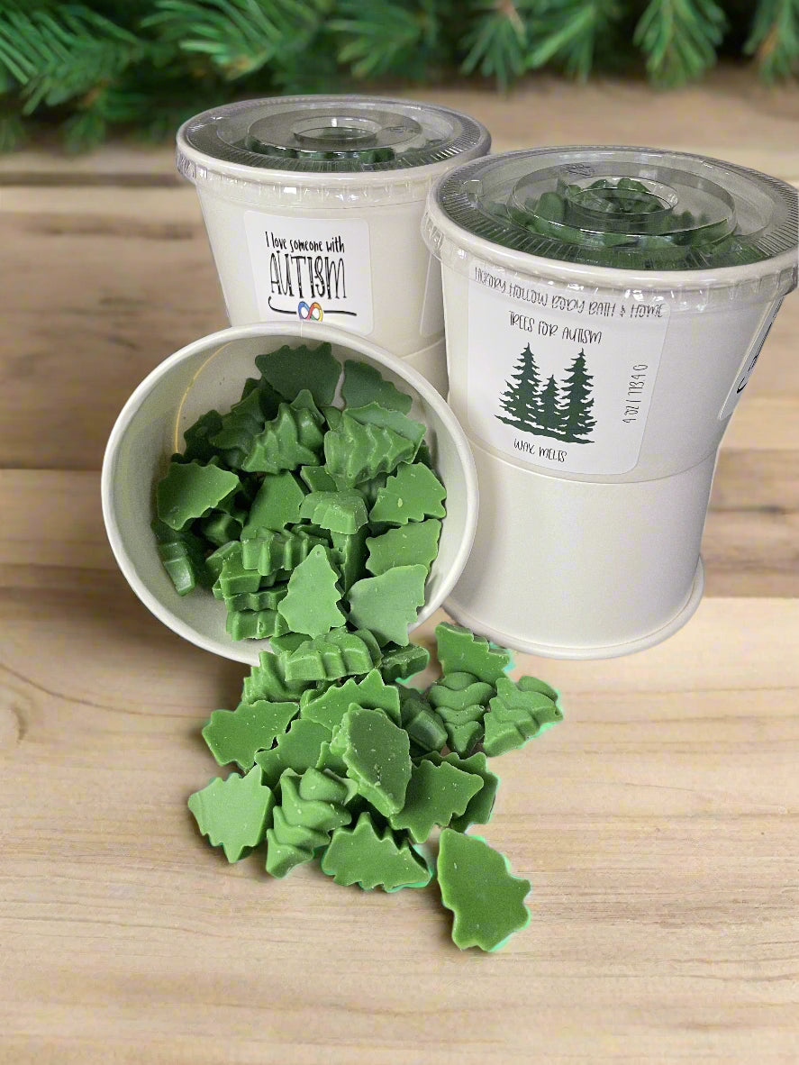 Trees for Autism wax melts in tree shapes, featuring a balsam scent in round and cup containers.